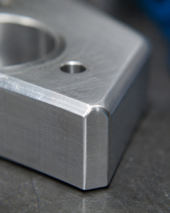 Close-up of a small chamfer and broken sharp edge on a CNC machined aluminium component